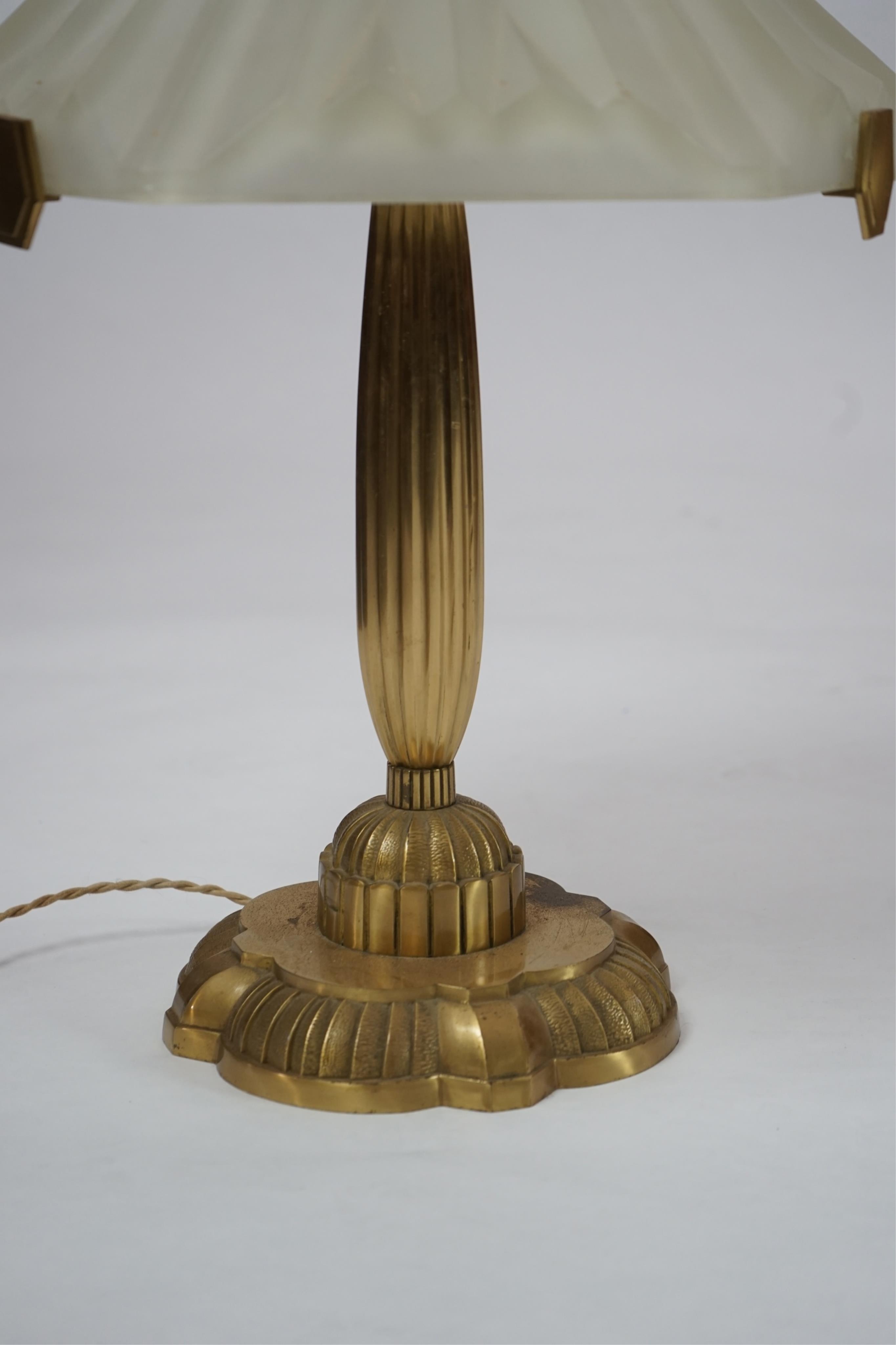 An Art Deco matt gilt brass table lamp with frosted glass shade